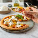 La auténtica receta de la pizza napolitana con pesto, tomates amarillos y burrata