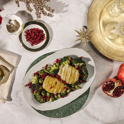 Hasselback Potatoes with Raclette Cheese, Brussels Sprouts, Broccoli and Pomegranate Recipe